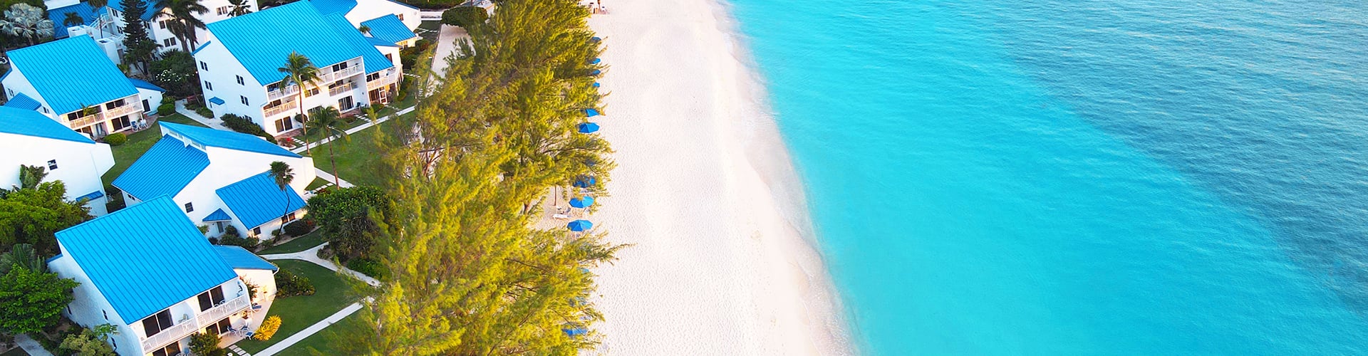Foreshore and Resort on Seven Mile Beach, Cayman Island with white sands and blue water.